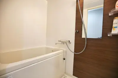 a bathroom with a bath tub and a mirror at QU101 Edogawa Japanese Style Apartment 101 has direct access to Akihabara and Shinjuku, with convenient transportation and free WiFi in Tokyo