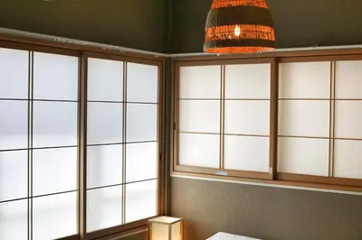 a room with four windows and a pendant light at QU101 Edogawa Japanese Style Apartment 101 has direct access to Akihabara and Shinjuku, with convenient transportation and free WiFi in Tokyo
