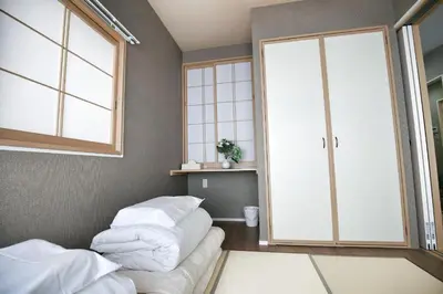 a bedroom with a bed and a large sliding glass door at QU101 Edogawa Japanese Style Apartment 101 has direct access to Akihabara and Shinjuku, with convenient transportation and free WiFi in Tokyo