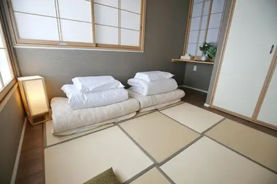 a room with a couch with pillows on it at QU101 Edogawa Japanese Style Apartment 101 has direct access to Akihabara and Shinjuku, with convenient transportation and free WiFi in Tokyo