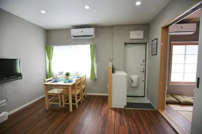a living room with a table and a dining room at QU101 Edogawa Japanese Style Apartment 101 has direct access to Akihabara and Shinjuku, with convenient transportation and free WiFi in Tokyo