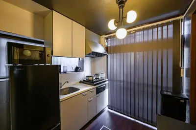 a kitchen with a black refrigerator and a sink at Premier suite Nishiazabu Roppongi front in Tokyo