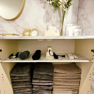 a closet with a shelf with shoes and a mirror at ueno minowa 502 in Tokyo