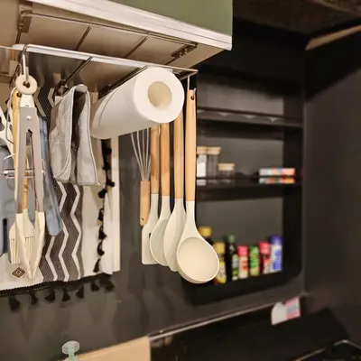 a bunch of kitchen utensils hanging from a wall at ueno minowa 502 in Tokyo