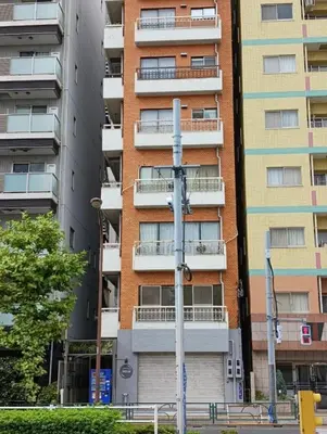 an apartment building with balconies on the side of it at ueno minowa 502 in Tokyo