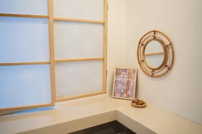 a room with a table with a mirror and a picture at Business Hotel Kankokukan - Vacation STAY 45862v in Tokyo