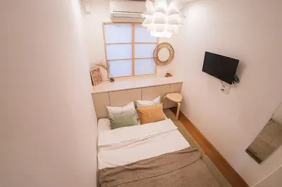a small room with a bed and a window at Business Hotel Kankokukan - Vacation STAY 45949v in Tokyo