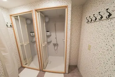 a shower in a bathroom with a glass door at Business Hotel Kankokukan - Vacation STAY 45949v in Tokyo