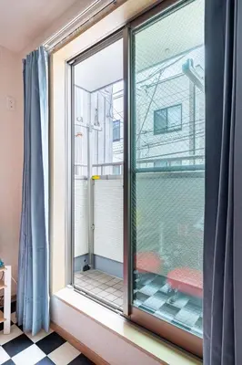 a window with a view of a balcony at CROWN \u8d8a\u4e2d\u5cf6 in Tokyo
