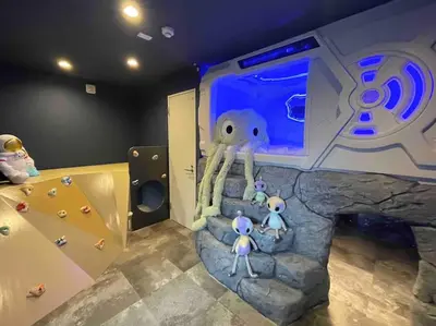 a childrens room with a rock wall and an aquarium at Holy Planet in Tokyo