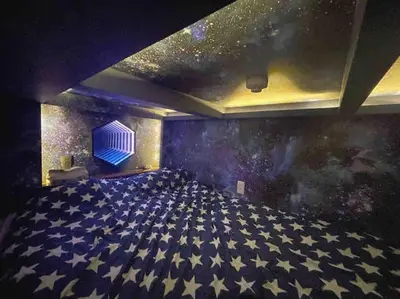 an empty room with stars on the wall at Holy Planet in Tokyo