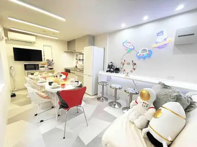 a kitchen and a living room with a table and chairs at Holy Planet in Tokyo