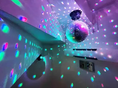 a purple room with a disco ball and lights at Holy Planet in Tokyo