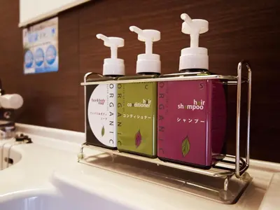 a group of three bottles of soap sitting on a bathroom sink at Super Hotel Shinjuku Kabukicho in Tokyo