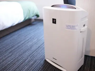 a white cooler sitting in a room with a bed at Super Hotel Shinjuku Kabukicho in Tokyo