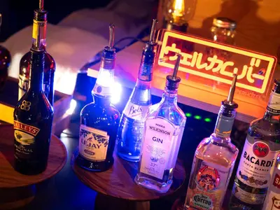 a group of bottles of alcohol sitting on a bar at Super Hotel Shinjuku Kabukicho in Tokyo