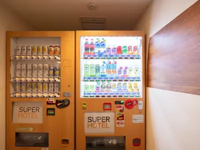 a vending machine filled with lots of water and soda at Super Hotel Shinjuku Kabukicho in Tokyo