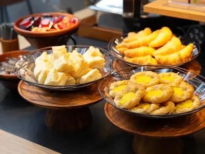three bowls of food on plates on a table at Super Hotel Shinjuku Kabukicho in Tokyo