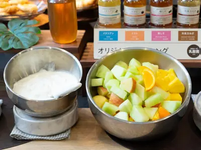 two metal bowls of fruit and yogurt on a counter at Super Hotel Shinjuku Kabukicho in Tokyo