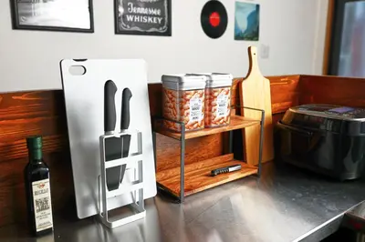 a kitchen with a refrigerator and a shelf with a bottle of wine at \u548c\u6c23\u4f1a\u3005\u90fd\u7acb\u5bb6\u653f Wakiaiai Toritsukasei in Tokyo