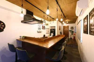 a bar with a wooden counter and chairs at \u548c\u6c23\u4f1a\u3005\u90fd\u7acb\u5bb6\u653f Wakiaiai Toritsukasei in Tokyo