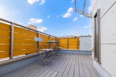 a balcony with a table and chairs on it at HAN'S EBISU - Shibuya - Entire House for Max 10 ppl in Tokyo