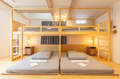 two beds in a room with a bunk bed at HAN'S EBISU - Shibuya - Entire House for Max 10 ppl in Tokyo