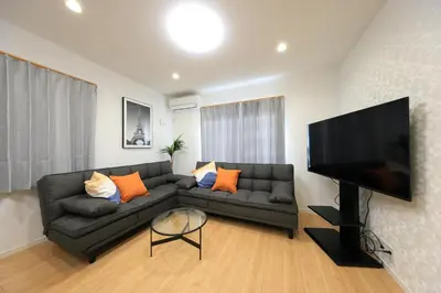 a living room with a couch and a flat screen tv at Bliss IKEBUKURO in Tokyo