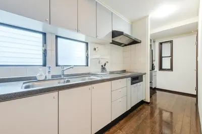 a kitchen with white cabinets and a sink at Family Stay Tokyo Hikifune in Tokyo