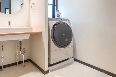 a washing machine in a bathroom next to a sink at Family Stay Tokyo Hikifune in Tokyo