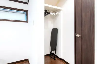 a room with a door and a television in it at Family Stay Tokyo Hikifune in Tokyo