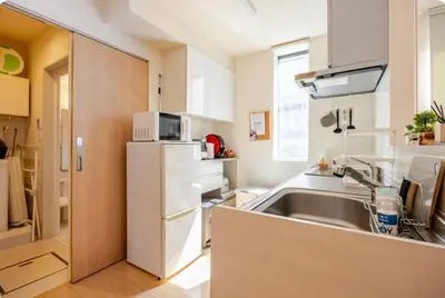 a kitchen with a sink and a white refrigerator at JRTakadababa 2min 5LDK 5beds 2unit room in Tokyo
