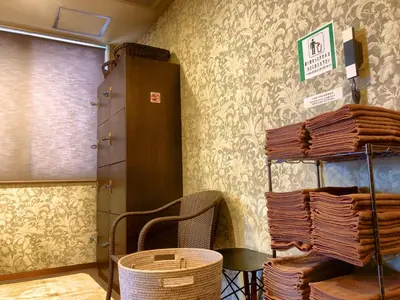 a room with a table and a shelf of baskets at Hotel Coco Grand Kitasenju in Tokyo