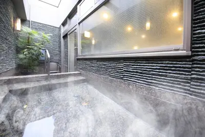a house with a pool in the middle of a building at Hotel Coco Grand Kitasenju in Tokyo