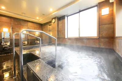 a bathroom with a bath tub with a sink at Hotel Coco Grand Kitasenju in Tokyo