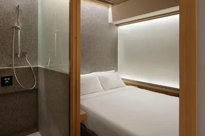 a small bedroom with a bed and a shower at KOYADO HOTEL Adult only check in starts from 10pm in Tokyo