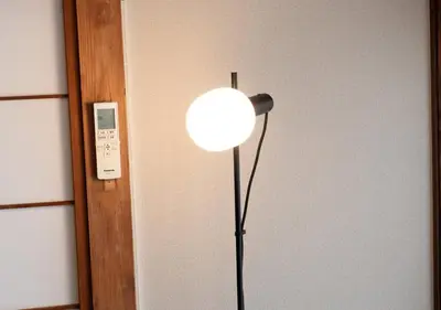 a floor lamp in a room next to a wall at Lido Urayasu in Tokyo