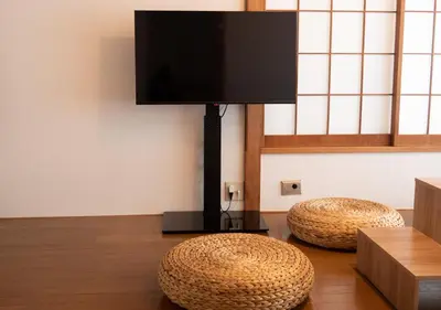 two ottoman stools in a room with a flat screen tv at Lido Urayasu in Tokyo