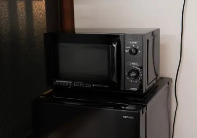 a microwave oven sitting on top of a refrigerator at Lido Urayasu in Tokyo