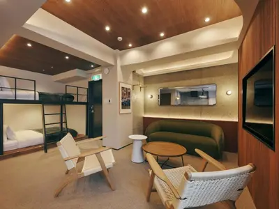 a living room with a couch and a bunk bed at illi Mani Shibuya in Tokyo