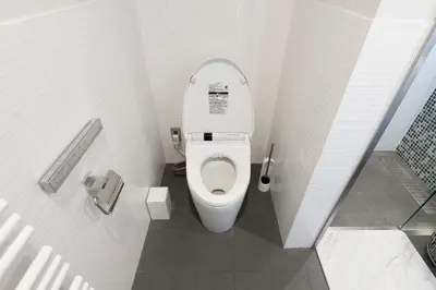 a small bathroom with a toilet in a stall at Courtyard HIROO in Tokyo
