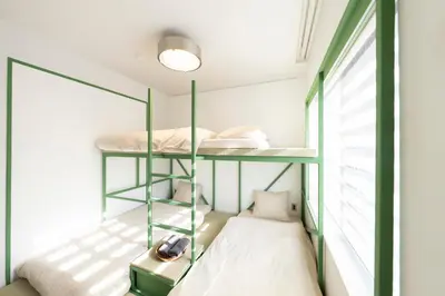 a room with two bunk beds and a window at Courtyard HIROO in Tokyo
