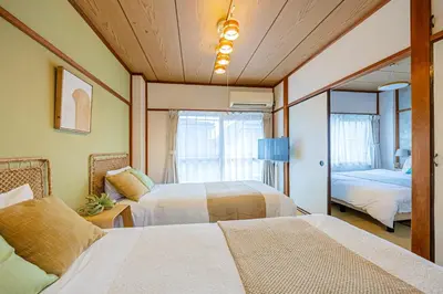 a bedroom with two beds and a mirror at Healing Palace Hirai tokyo down town in Tokyo