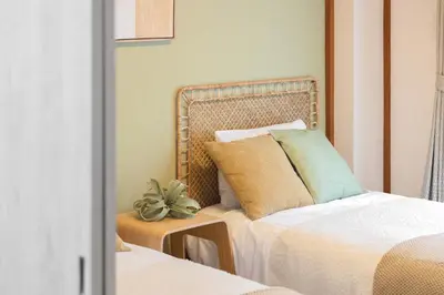 a bedroom with two beds and a plant on a table at Healing Palace Hirai tokyo down town in Tokyo