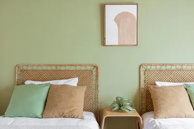 two beds in a room with green walls at Healing Palace Hirai tokyo down town in Tokyo