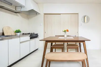 a kitchen with a wooden table and two chairs at Healing Palace Hirai tokyo down town in Tokyo