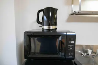 a coffee pot sitting on top of a microwave at Healing Palace Hirai tokyo down town in Tokyo