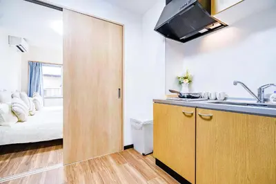 a kitchen with a sink and a room with a bed at Shinjuku Ryokan Retreat丶Local Tokyo Experience & Short Trips Hub丶walk to Shinjuku station Y05C in Tokyo
