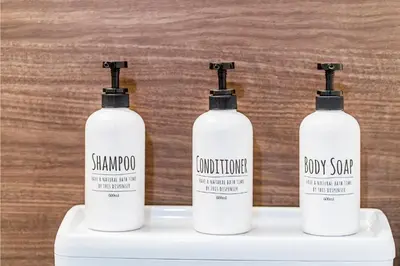 three bottles of shampoo and conditioner sitting on a shelf at Shinjuku Ryokan Retreat丶Local Tokyo Experience & Short Trips Hub丶walk to Shinjuku station Y05C in Tokyo