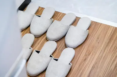 a row of gray socks on a wooden floor at Shinjuku Ryokan Retreat丶Local Tokyo Experience & Short Trips Hub丶walk to Shinjuku station Y05C in Tokyo